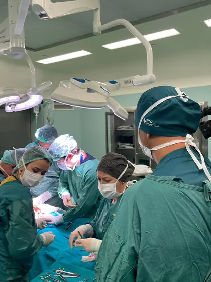 Surgeons and theatre staff gathered around the operating table