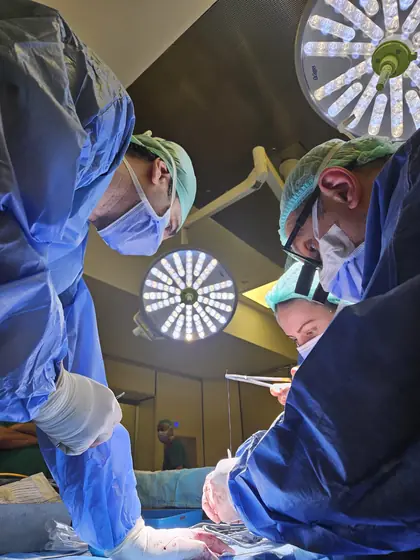 Surgeons operating under the theatre lights