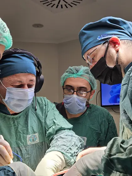 Surgeons in theatre caps and masks during an operation