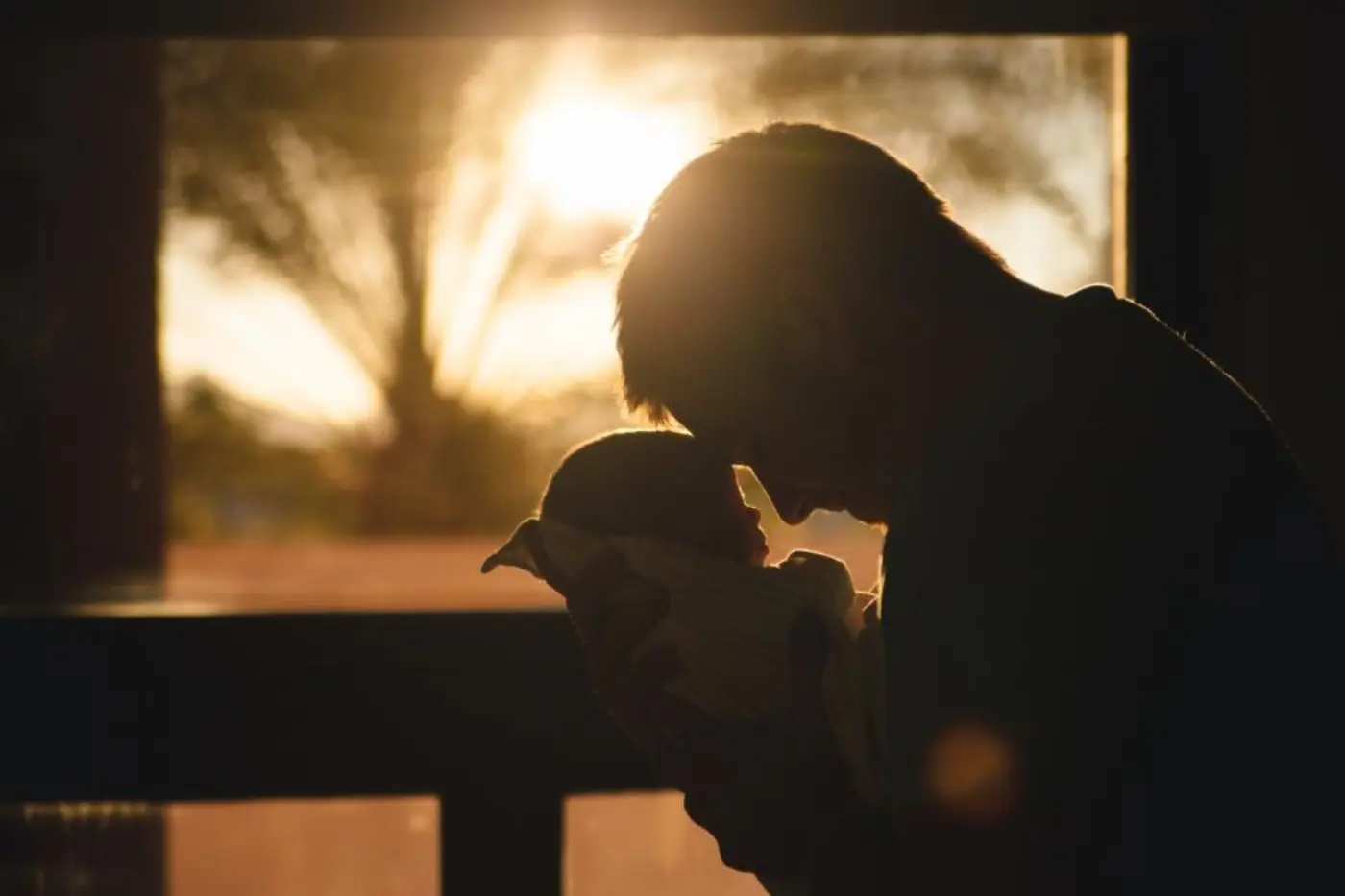 A father and a young child walking in a park