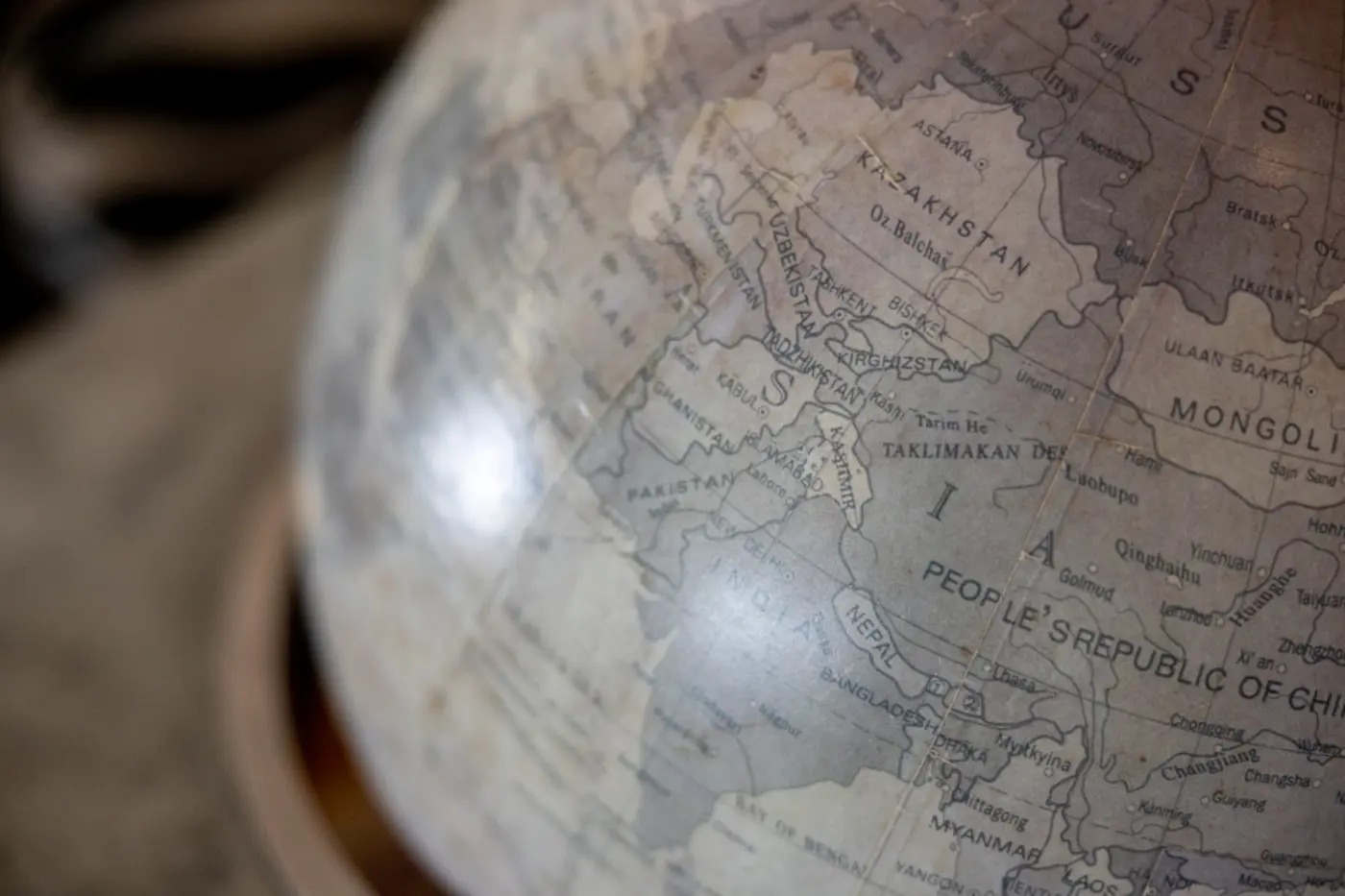 A world map with pins on a wooden desk