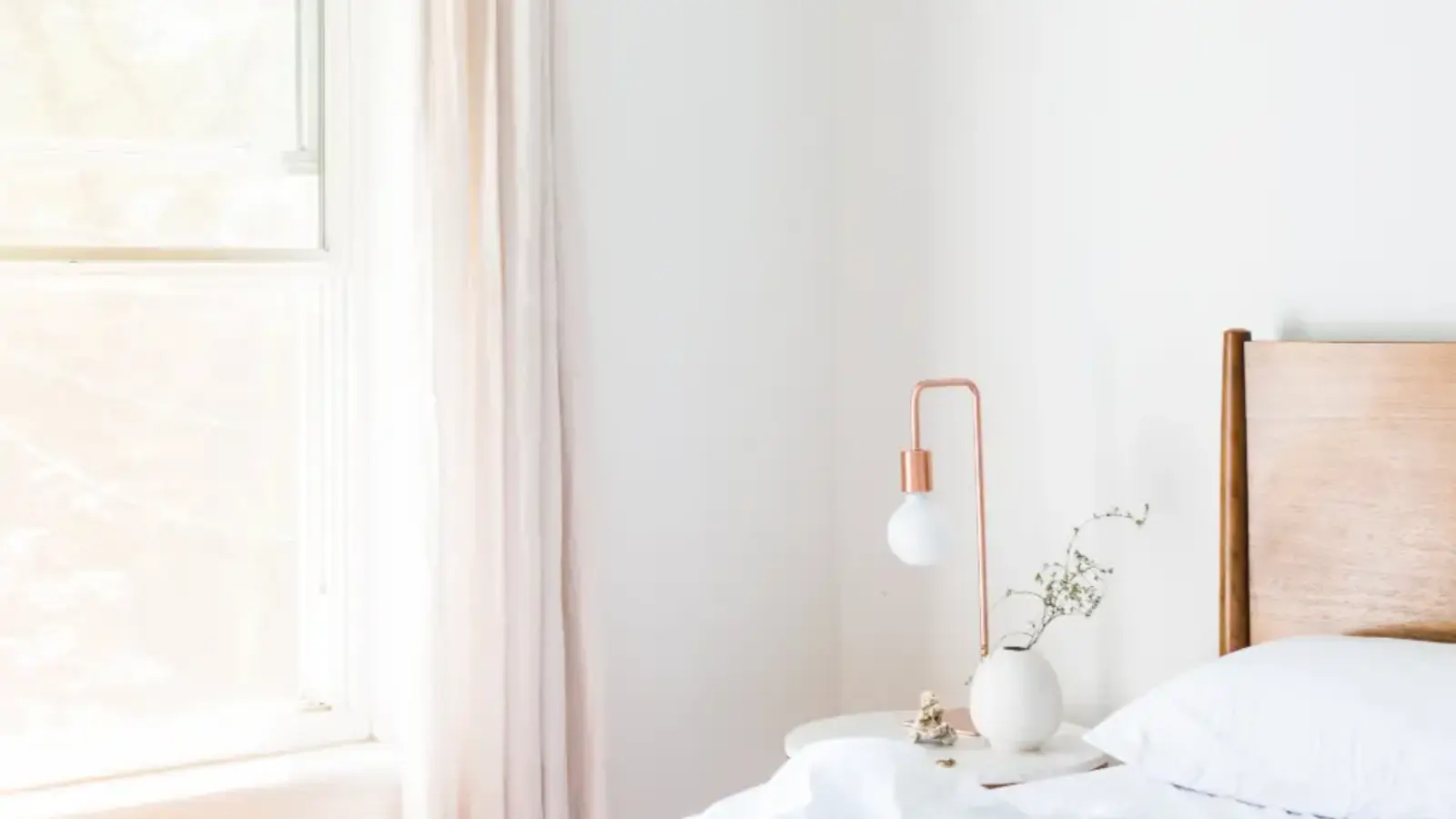 A bright, tidy bedroom in morning light