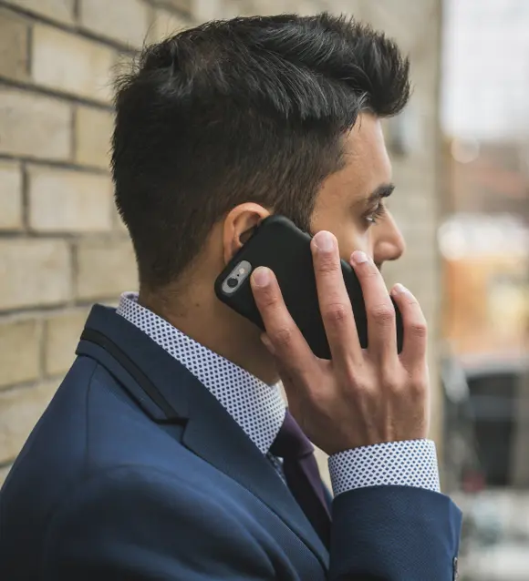 Man in a suit talking on a mobile phone